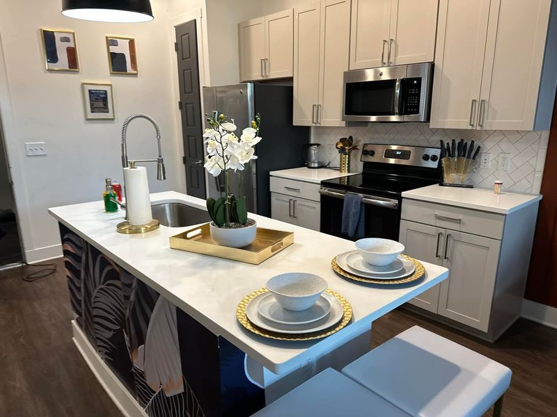 Guest-ready kitchen island with place settings staged after an Airbnb turnover clean